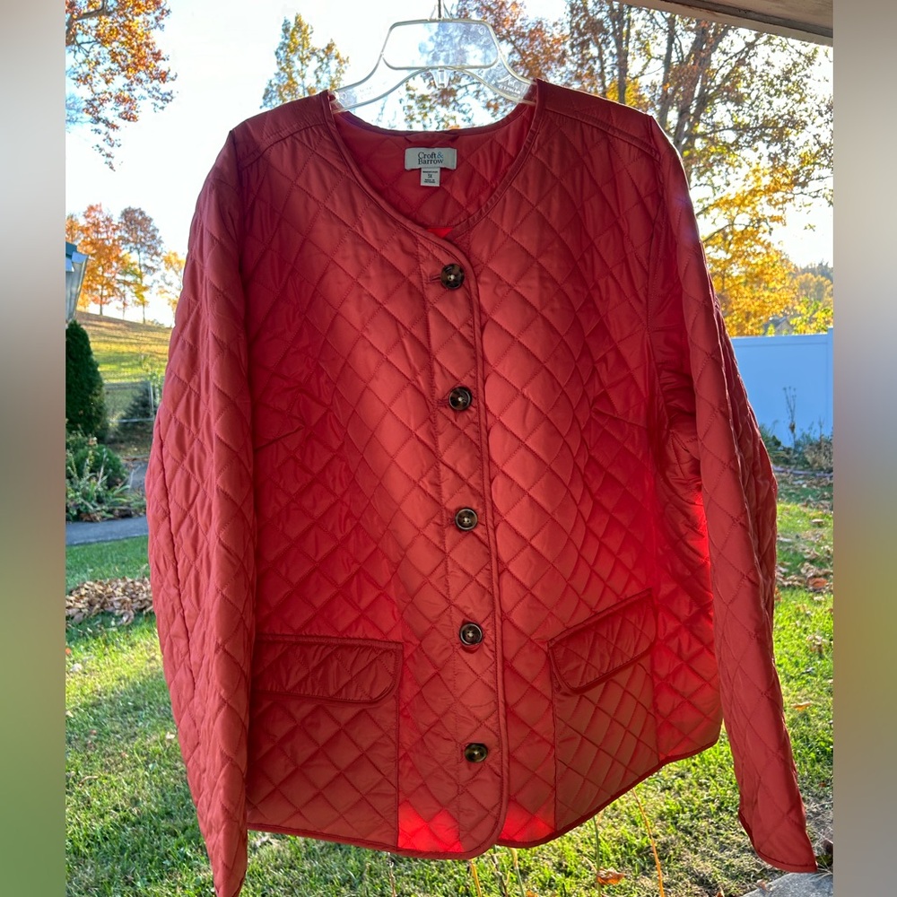 Salmon colored ladies, quilted light weight jacket with button up front